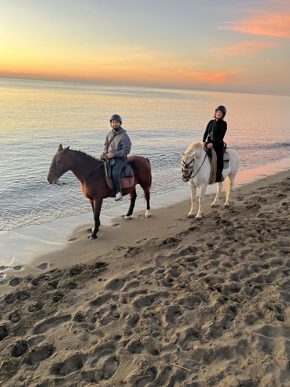 Sidarth on horseback on a beach at sunrise