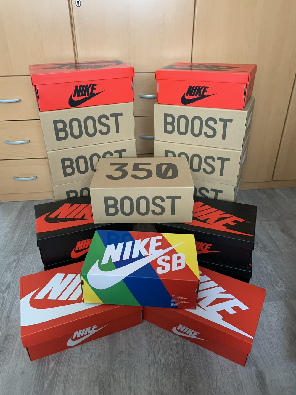 A large stack of sneaker boxes from Nike and Yeezy