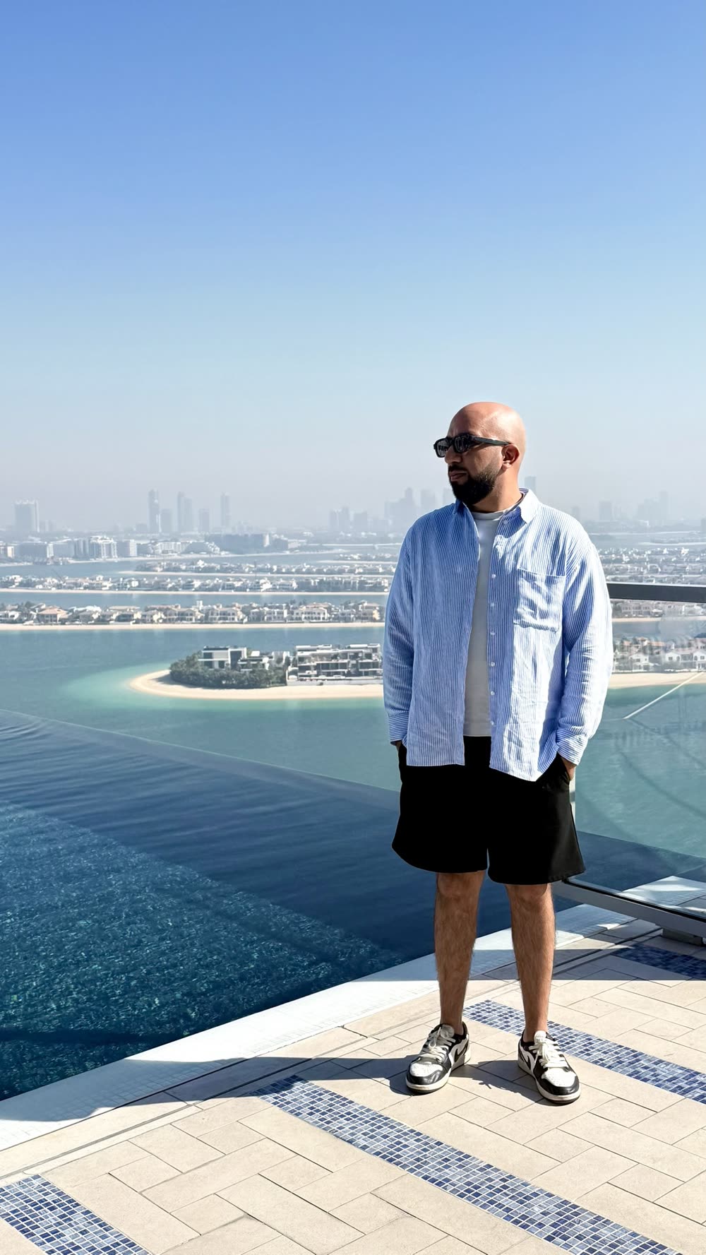 Sidarth on a rooftop pool overlooking Palm Jumeirah in Dubai