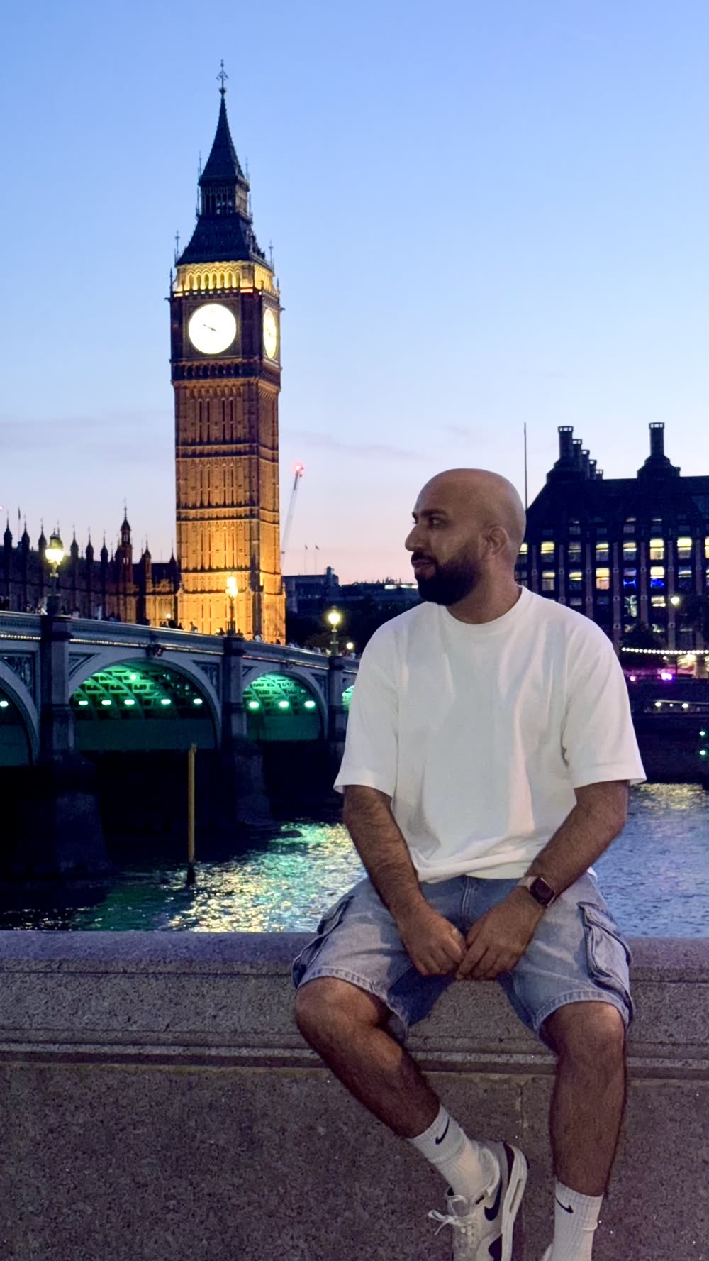 Sidarth sitting near Big Ben in London at dusk